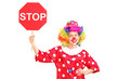 A clown holding a stop sign