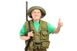 A male hunter with shotgun giving a thumb up