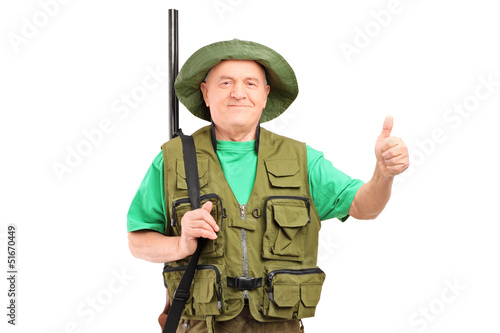 Photo: A male hunter with shotgun giving a thumb up A male hunter with shotgun giving a thumb up