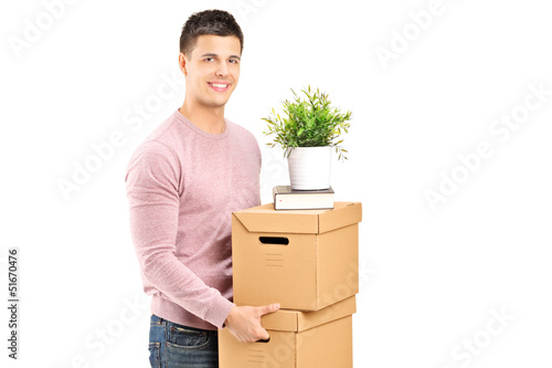 Photo: A young man carrying removal boxes A young man carrying removal boxes