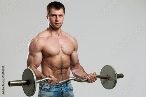 Photo: Handsome guy working out with dumbbells Handsome guy working out with dumbbells
