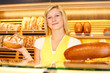 Bakery shopkeeper with two loafs of bread