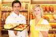 Baker and shopkeeper present pastry