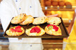 Baker and shopkeeper present pastry