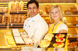 Baker and shopkeeper present pastry