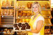 Shopkeeper in bakery presents tablet of rum balls