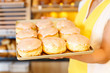 Bakery shopkeeper presents doughnuts