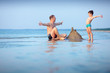 Young father and his son having fun at beach