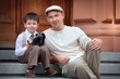 Photo: Father and little son with retro camera outdoors Father and little son with retro camera outdoors