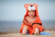 Cute little boy wearing tiger towel outdoors