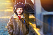 sunlight Boy homeless bum on street freezing close to railway ca