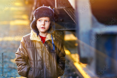 Photo: sunlight Boy homeless bum on street freezing close to railway ca sunlight Boy homeless bum on street freezing close to railway ca