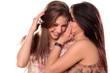 Two teenage girls gossiping and laughing