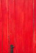 Handmade red painted old wooden door with door lock