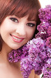 Young woman with flowers on white background