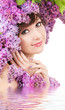 Young woman with lilac flowers