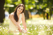 Cute woman rest  in the park with dandelions