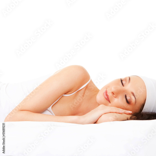 Photo: Cute woman sleeps on the white bed Cute woman sleeps on the white bed