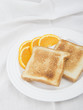 Photo: Unbuttered toast on white plate garnished with orange slices Unbuttered toast on white plate garnished with orange slices