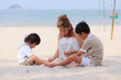Photo: Asian mom and son playing on beach Asian mom and son playing on beach