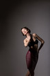 Femininity. Daydreaming Woman in Studio over Grey Background