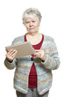 Senior woman using tablet computer looking confused