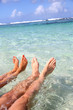 Photo: Closeup of couple's feet in lagoon water Closeup of couple's feet in lagoon water