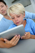 Foto: Father and son using digital tablet at home Father and son using digital tablet at home