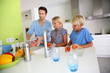 Father with kids preparing tomatoe salad
