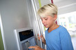 Photo: Young boy drinking water from fridge Young boy drinking water from fridge
