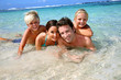 Couple and children in crystal clear water