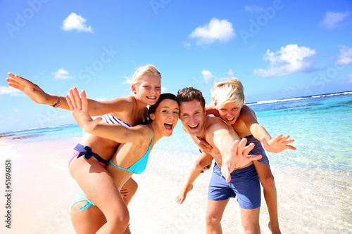 Photo: Family of four having fun at the beach Family of four having fun at the beach