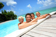 Photo: Family of four bathing in swimming pool Family of four bathing in swimming pool