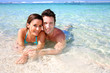 Portrait of cheerful couple in Caribbean sea