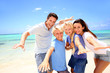 Happy couple with kids at the beach Happy couple with kids at the beach