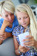 Teenagers using smartphone with earphones