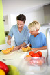 Father and child preparing melon for dinner