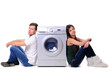 beautiful young couple with a washing machine