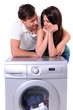 beautiful young couple with a washing machine