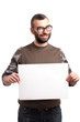 Photo: Young man with beard holding blank board Young man with beard holding blank board