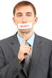 Young businessman with a band on his mouth isolated on white