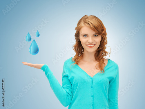 Photo: woman showing blue water drops woman showing blue water drops