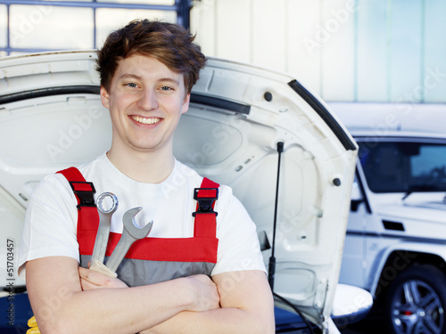 Photo: Car mechanic is satisfied with his job Car mechanic is satisfied with his job