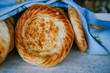 Traditional eastern lepeshka nan - white flat bread baked in old