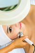 Asian woman getting a facial treatment in spa