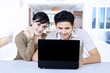 Happy couple surfing internet at home