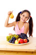 Photo: Girl with pear and plate of fruit Girl with pear and plate of fruit