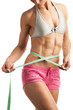 Photo: Young fitness woman with measuring tape over white Young fitness woman with measuring tape over white