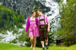 canvas print picture - Happy couple hiking in Alpine meadow