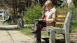 Senior Woman Reading Magazine In The Park